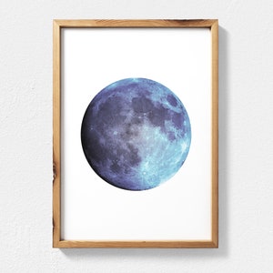 May include: A framed print of a blue and purple moon with a white background.