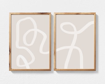 May include: Two framed abstract art prints with a beige background and white line drawings. The prints are in wooden frames.