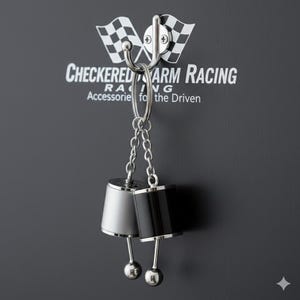 May include: Silver and black racing-themed keychain hanging from a metal hook. The keychain features two cylindrical charms with ball-shaped bottoms. The background is dark gray with the text "CHECKERED ARM RACING" and checkered flags.