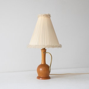 Table lamp made of teak and brass with a pleated textile shade, Sweden 1950s
