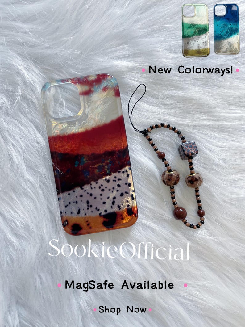 May include: A clear phone case with a layered design in shades of red, brown, white, and gold, with a matching beaded wrist strap. The case has the text "SookieOfficial" and "MagSafe Available". Two additional colorways are shown.