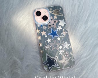 May include: Clear phone case with a space-themed design. The case features a pattern of stars in various sizes and colors, including blue, silver, and white. A planet graphic is at the top. The text "SookieOfficial" is at the bottom.