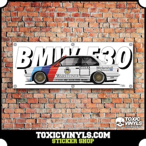 May include: A white BMW E30 racing car with blue and red accents. The car has a Warsteiner sponsor logo on the side. The car is on a white banner with the text "BMW E30" in black.