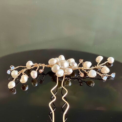 Costume hair jewelry of a vine hand shops crafted with 14k gold filed, natural pearls and Swarovski crystals.