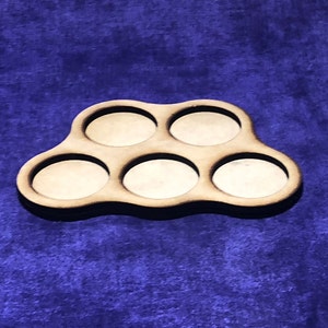May include: A wooden tray with six circular cutouts, perfect for holding small items like dice or coins. The tray is brown and has a natural wood finish.