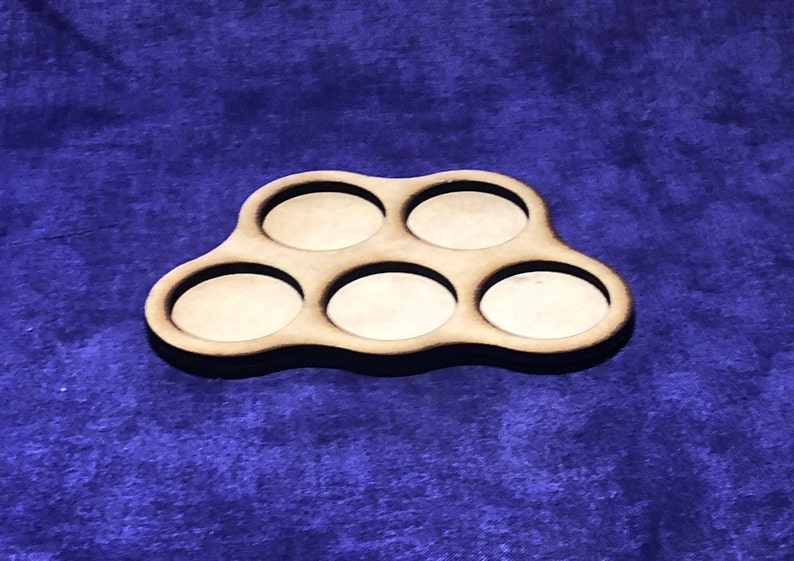 May include: A wooden tray with six circular cutouts, perfect for holding small items like dice or coins. The tray is brown and has a natural wood finish.