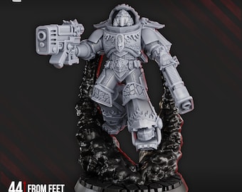 May include: A gray miniature figure of a warrior in detailed armor, holding a futuristic weapon. The figure is 44 mm tall from feet to eyes. The base is dark gray, and the figure is surrounded by a dark, textured substance. The DakkaDakka.Store logo is in the top left corner.