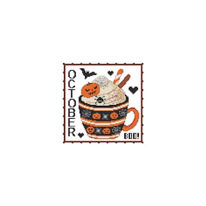 May include: A cross-stitch pattern featuring a black and orange mug with a white whipped cream topping, a candy cane, and a spider. The mug is decorated with orange pumpkins and black spiderwebs. The text "OCTOBER" is on the left side of the mug and "BOO!" is on the right side.