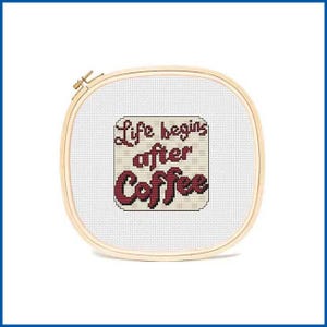 May include: A cross-stitch embroidery hoop with a white background and a red and white sign that reads "Life begins after coffee".