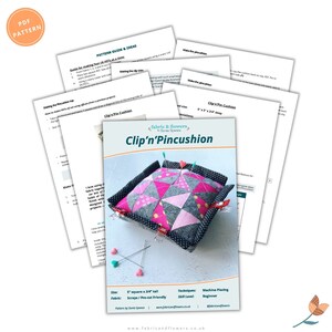 May include: A sewing pattern for a clip-on pincushion. The pattern is called "Clip'n'Pincushion" and is designed by Sonia Spence. The pattern is for a 5-inch square pincushion that is 3/4 inch tall. The pattern is made with scraps of fabric and is beginner-friendly.