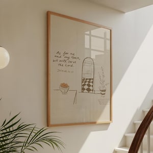 May include: A framed wall art print featuring a beige background with a simple black line drawing of a bowl of fruit, a doorway, and a potted plant. The text reads: As for me and my House, we will serve the Lord. Joshua 24:15 in black script.