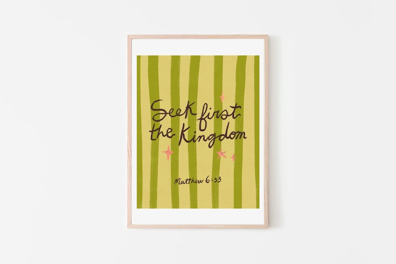 May include: A framed art print with the text "Seek first the Kingdom" in black script. The background features vertical green stripes on a yellow-green field, with pink star accents. The text "Matthew 6:33" is below the main text.