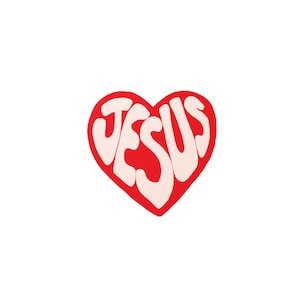May include: A red heart-shaped design with the word "JESUS" written in white inside.