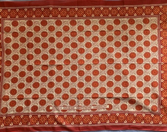 Single Khanga in orange and black African print fabric, kanga cloth from Zanzibar