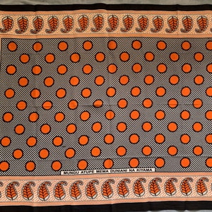 Single Khanga in orange and black African print fabric, kanga cloth from East Africa