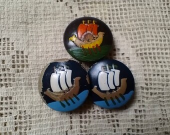 Three vintage 1949s wooden, painted buttons with Viking longship design