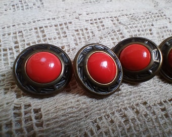 Seven vintage, 1980s red plastic and metal dress buttons with plastic shanks.