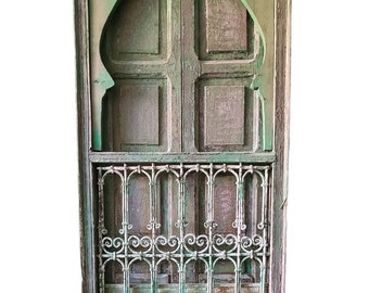 A vintage window wrought iron filigree artwork metal ethnic african window old world architectural Moroccan wood work piece