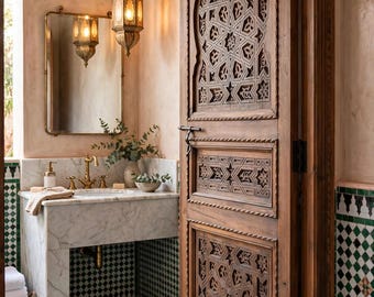 May include: A wooden door featuring intricate geometric carvings and a pointed arch panel. The bathroom includes a white marble vanity with a brass faucet, a rectangular mirror, two hanging metal lanterns, and green and white checkered floor tiles.