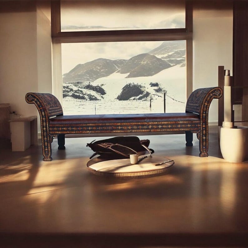 May include: A dark brown leather bench with intricate inlaid designs. The bench has a curved back and armrests and sits in front of a large window with a snowy mountain view.