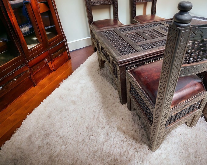 One of a kind vintage brown wooden and leather moorish mousharabia set with four chairs and a table Moroccan living room furniture