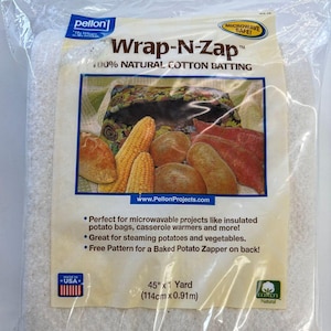 May include: A package of white cotton batting labelled "Wrap-N-Zap" 100% Natural Cotton Batting. The package shows a variety of vegetables and a loaf of bread inside a white cotton bag. The package is microwave safe and measures 45 inches by 1 yard (114 cm x 0.91 m).