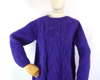 May include: A vibrant purple sweater with a crew neck and long sleeves. The knitted design features a repeating pattern of openwork leaf shapes. The sweater is displayed on a mannequin against a white background.
