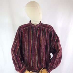 May include: A striped, multi-colored, long-sleeved button-up shirt with a relaxed fit.