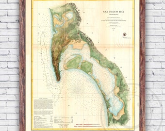 May include: An antique nautical chart of San Diego Bay, California, from 1857. The chart is printed on aged paper with a faded yellowed background. The chart shows the coastline of San Diego Bay with detailed markings for depths, shoals, and other navigational features. The chart is framed in a dark wood frame.