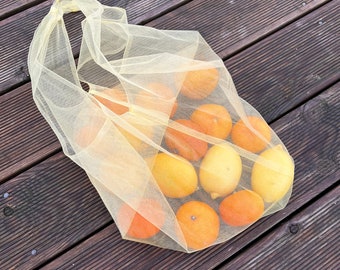 Yellow ecofriendly transparent bag. Shopping bag. Net bag.  Tulle bag. Reusable bags for buying fruits and vegetables. Shopper