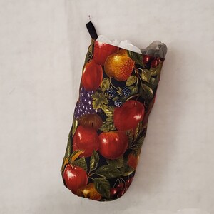 May include: A black fabric bag with a drawstring closure and a fruit print design. The bag is filled with plastic bags.