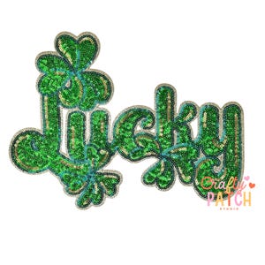 May include: A green sequined patch with the word "Lucky" in a whimsical font, featuring shamrock accents. The patch has a silver border and is designed for St. Patrick's Day or other festive occasions.