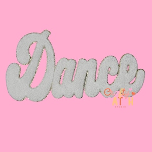 May include: White, textured "Dance" patch with gold trim, set against a pink background. The word is in a cursive font, perfect for decorating clothing or accessories. The patch has a glittery outline.