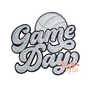 May include: A silver sequined patch with the words "Game Days" in a script font, with a volleyball graphic. The patch has a black border and the text is filled with small, shiny sequins. The patch also includes the text "Pretty Patch Studio".