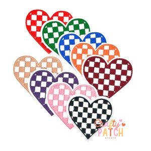 May include: A collection of heart-shaped patches in various colors, including red, green, blue, orange, burgundy, tan, purple, pink, and black. Each patch features a checkered pattern. The patches are arranged on a white background.