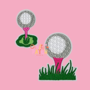 May include: Embroidered golf ball patches. The golf balls are gray with white detailing, sitting on pink tees, and green grass. The patches are on a pink background. The text "Crafty Patch Studio" is in the image.