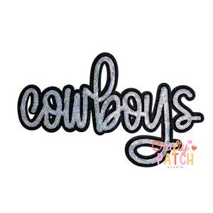 May include: A sequined patch with the word "Cowboys" in a cursive font. The letters are silver with a black outline. The patch has a white background and the words "Crazy Patch Studio" in the bottom right corner.