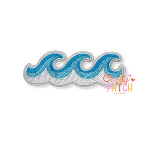 May include: An embroidered patch featuring three stylized ocean waves in shades of blue and white. The design has a thick, light gray border outlining the wave shapes. The embroidery thread creates a textured appearance across the surface.