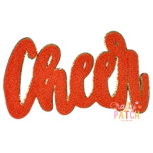 May include: Orange chenille patch with the word "Cheer" in a cursive font. The patch has a gold glitter border and is on a white background. The Crafty Patch Studio logo is in the bottom right corner.