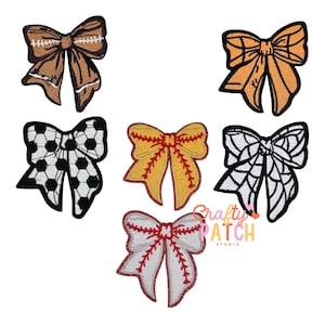 May include: A collection of embroidered bows in various sports themes. Includes a football, soccer ball, baseball, softball, and a spiderweb design. The bows are in shades of brown, orange, yellow, white, and black.