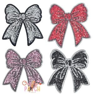 May include: Four sequined bow patches in silver, red, pink, and black. Each bow has a contrasting border and is densely covered in sequins. The bows are arranged against a white background, showcasing their colors and textures.