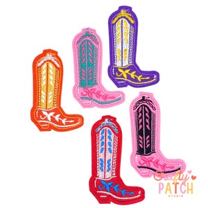 May include: A collection of colorful embroidered cowboy boot patches in various colors, including orange, pink, red, and purple. Each patch features detailed stitching and floral accents, perfect for adding a touch of Western flair to clothing or accessories.