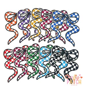 May include: A collection of colorful, checkered bow patches in various colors, including orange, purple, yellow, red, green, blue, and black. Each patch has a white border and a unique checkered pattern. The patches are arranged in two rows.