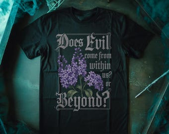 May include: Black t-shirt with a graphic design featuring a purple flower and the text "Does Evil come from within us? or Beyond?"