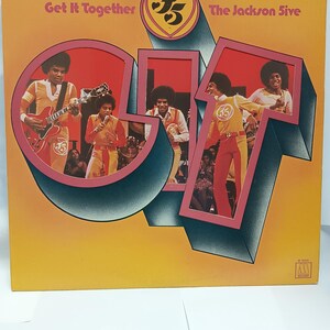 May include: Album cover for "Get It Together" by The Jackson 5. The cover features the band members in orange and yellow outfits. The album title and band name are displayed in a stylized font against a yellow and orange background.