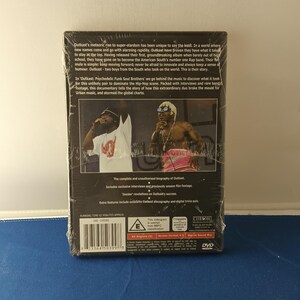 May include: A shrink-wrapped DVD case featuring the Outkast documentary titled Psychedelic Funk Soul Brothers. The back cover displays two performers on stage, a barcode, a BBFC E rating symbol, and text detailing the film's content.