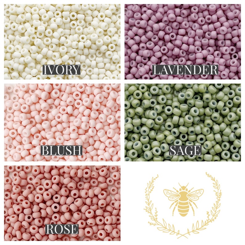 May include: Assortment of small round beads in various colours, including ivory, lavender, blush, sage, and rose. The beads are arranged in a grid pattern with the colour names written below each section. A small bee illustration with a wreath is in the bottom right corner.