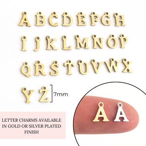 May include: Gold letter charms in the alphabet A through Z, each charm is 7mm in size. The charms are available in gold or silver plated finishes.