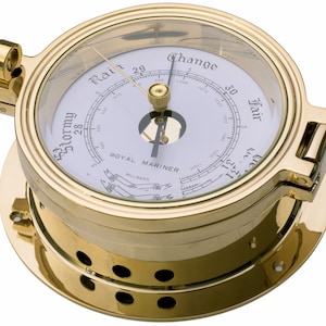 May include: A brass barometer with a white face and a black needle. The face has markings for "Stormy", "Rain", "Change", and "Fair". The barometer is labeled "Royal Mariner" and has a scale in millibars.