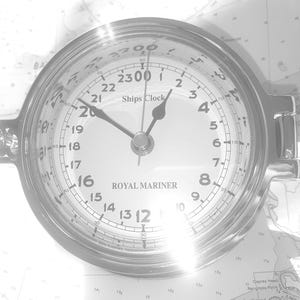 May include: A silver ship's clock with black hands and a white face. The clock face has black numbers and the text "Ships Clock" and "Royal Mariner".